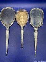 Front view of two mirrors and brush showing overall design and wear