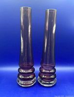 Front view of both amethyst Dartington vases showing full shape and color