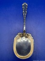 Full view of sterling serving spoon showing gold-washed bowl and ornate handle