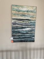 Full view of the large abstract painting hanging on a wall showing horizontal layered brushstrokes and textural highlights in muted blues, grays, and beige.