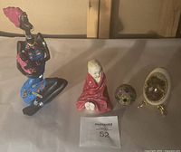 Full set of 4 visible items from the set displayed on neutral background, showing figurines and collectible eggs