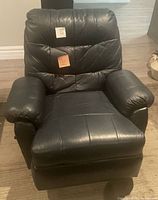 Front view of upright recliner showing padded back, arms and seat