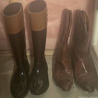 Photo showing both pairs of boots side by side: black and tan rain boots and brown leather cowboy boots.