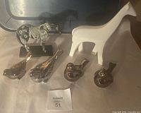 Overview of six animal figurines including four birds and two horses showing detailed designs and materials