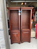 Front view of two mahogany hardwood display cabinets with closed lower cabinet doors