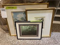Photo showing all three framed artworks grouped together on carpet, showing size labels of 18x15 and 11.5x9 inches.