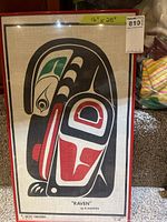 Full view of the framed artwork showing the stylized raven design on linen.