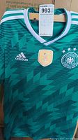 Green Adidas Germany national soccer team FIFA jersey size small hanging, showing front details and labels