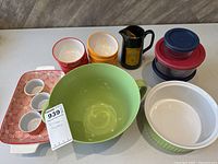 Photo showing assortment of ramekins, bowls, pouring jug, and storage containers