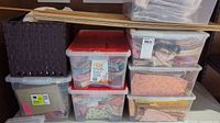 Stacked plastic storage totes containing fabric and notions
