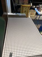 Top surface showing white cutting mat with black grid and yard/inch markings