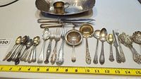 Overall lot layout with tray, cup, flatware and strainers.