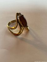 Front view of gold filled ring showing marquise brown stone and bypass design