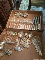 Boxes showing large assortment of sterling handled flatware
