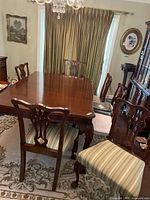 Overall view of mahogany dining table with six chairs in dining room