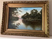 Full view of framed painting showing landscape and ornate frame