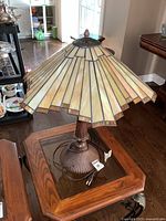 Full view of lamp on table showing shade and base