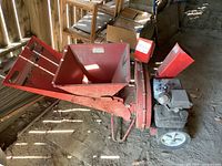 Full view of chipper showing intake hopper, wheels and frame