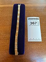 Full bracelet on display pad with appraisal card visible