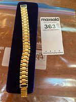 Full view of bracelet on velvet pad with appraisal sheet partially visible