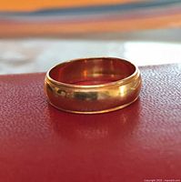 Ring side view showing polished yellow gold finish and milgrain edge