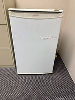 Front view of white Simplicity compact refrigerator closed