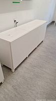 Front angled view of full white storage cabinet
