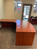 Full view of L-shaped curved desk in office setting