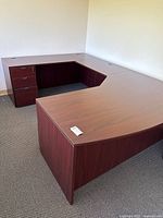 Front angle showing full U-shaped desk with pedestal drawers