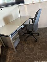 Desk, office chair and file cabinet under desk
