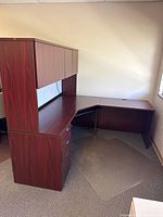 Full view of L-shaped desk, pedestal drawers, hutch, floor mat