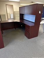 Assembled L-shaped desk ensemble with hutch, pedestal, keyboard tray