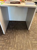 Full view of desk extension showing overall structure and carpet for scale
