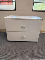 Front view showing two drawers, recessed pulls, lock