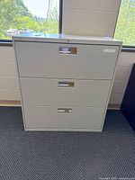 Front view showing three drawers, handles, lock core, overall color and condition