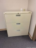 Front view of HON 3-drawer metal lateral file cabinet