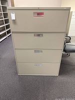 Front view of beige HON 4-drawer lateral file cabinet