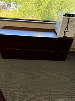 Front view of lateral file cabinet with two drawers and printer on top