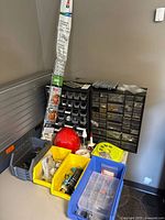 Overview of tabletop showing two parts cabinets, bins, Cordmate kit, hard hat, adhesive tube