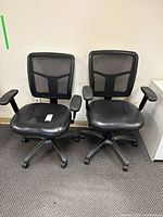 Front view of both matching black mesh office chairs