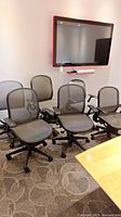 Group of six mesh office chairs