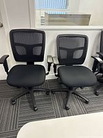 Both mesh office chairs side by side showing backs, seats and bases