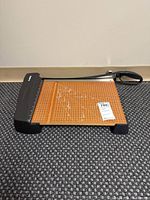 Full view of X-Acto guillotine paper cutter showing board, cutting arm, overall appearance