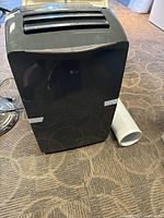 Front view of LG portable air conditioner with exhaust hose