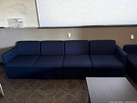 straight view of four connected navy sofa modules