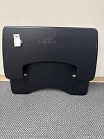 Front view of black standing desk platform