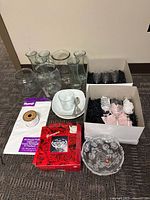 Entire lot laid out: Georgina bowl in box, flutes, vases, cup and saucer, jar, twine, produce bags