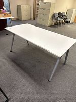 Overall view of white adjustable office table