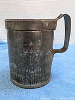 Front view showing cylindrical body and handle