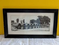 Full view of framed photograph against yellow wall